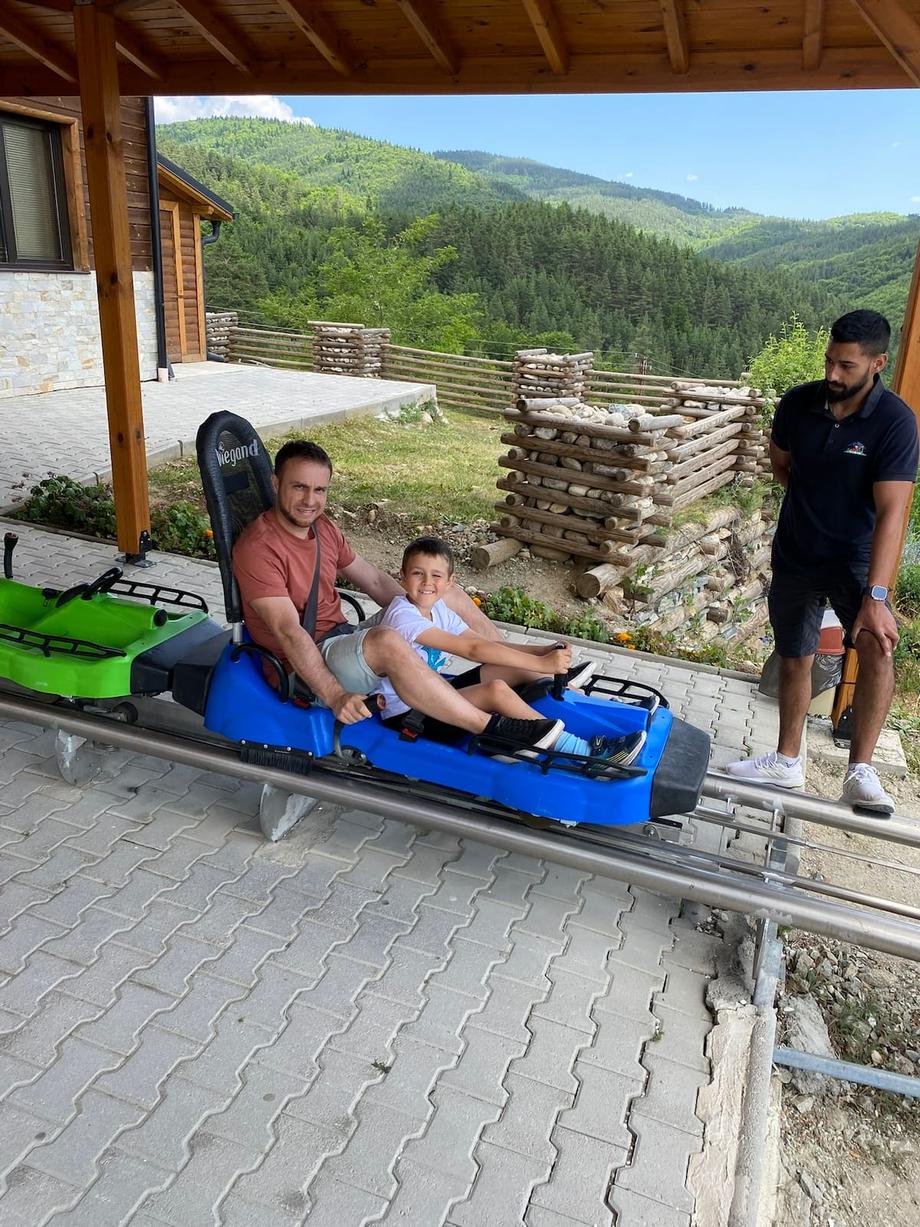Anton and dad riding the mini roller coaster